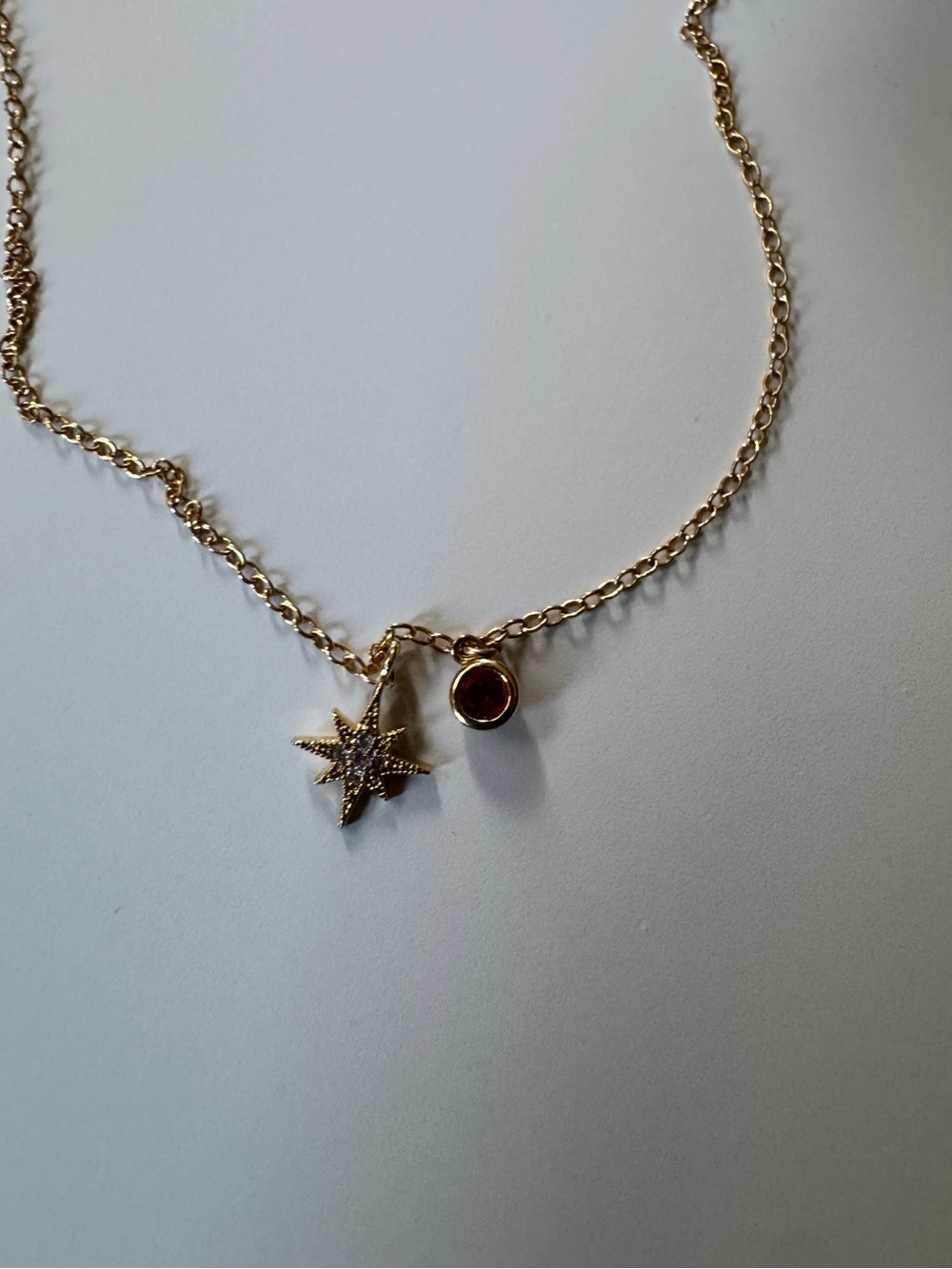Gold Star Charm Necklace with Red Gem
